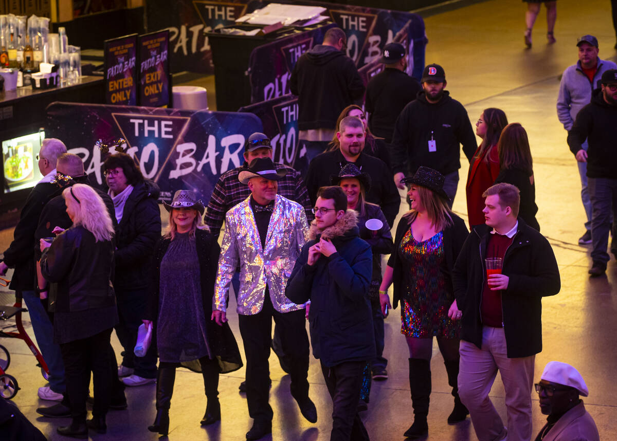 New Year's Eve revelers walk around the Fremont Street Experience Tuesday, Dec. 31, 2024, in do ...