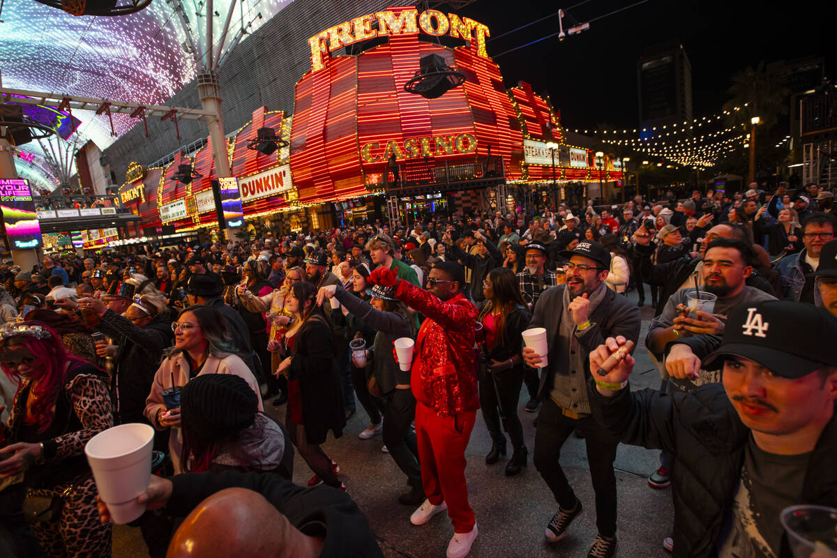 People dance to music during the New Year’s Eve celebration at the Fremont Street Experi ...