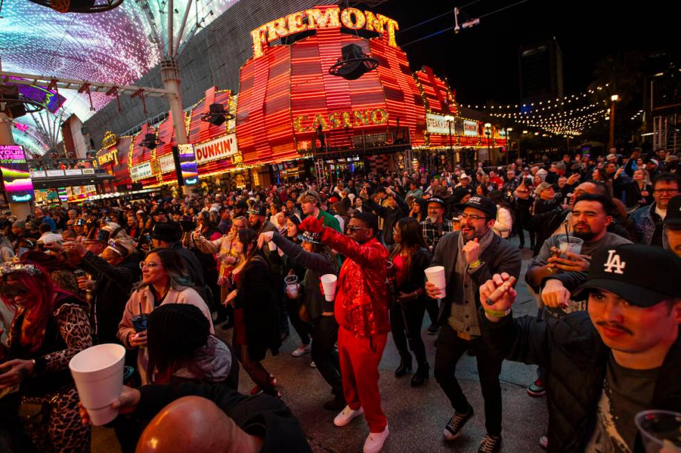 People dance to music during the New Year’s Eve celebration at the Fremont Street Experi ...