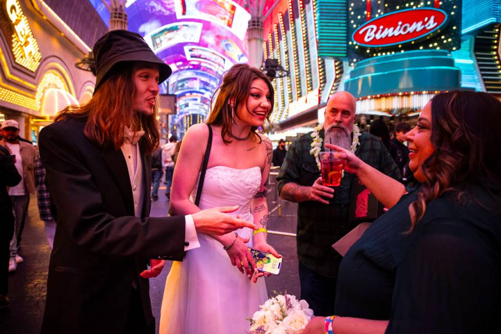 Newlyweds Drew and Lexi Eslinger, of Las Vegas, greet fellow newlyweds Josh Leslie and Myla May ...