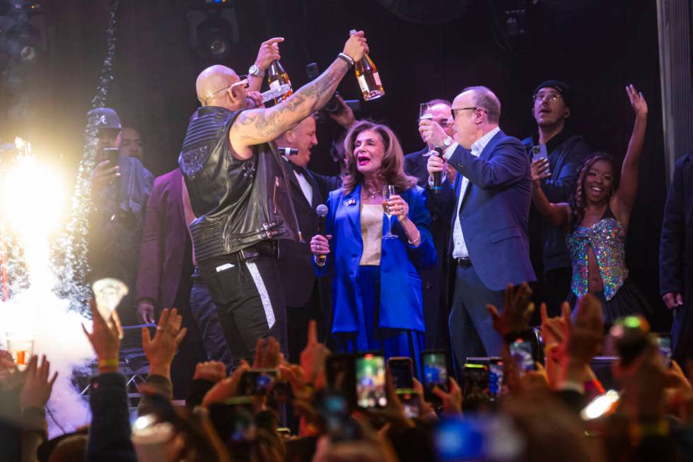 Las Vegas Mayor Shelley Berkley, center right, rings in the New Year on stage with Flo Rida, le ...