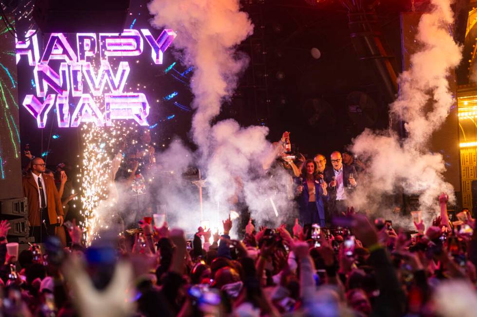 Las Vegas Mayor Shelley Berkley, center right, rings in the New Year on stage with Flo Rida and ...