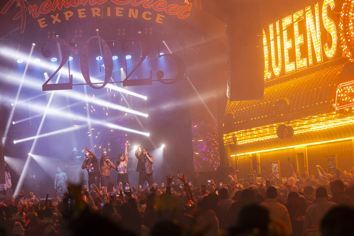 Flo Rida, right, rings in the New Year on stage during the New Year's Eve celebration at the Fr ...