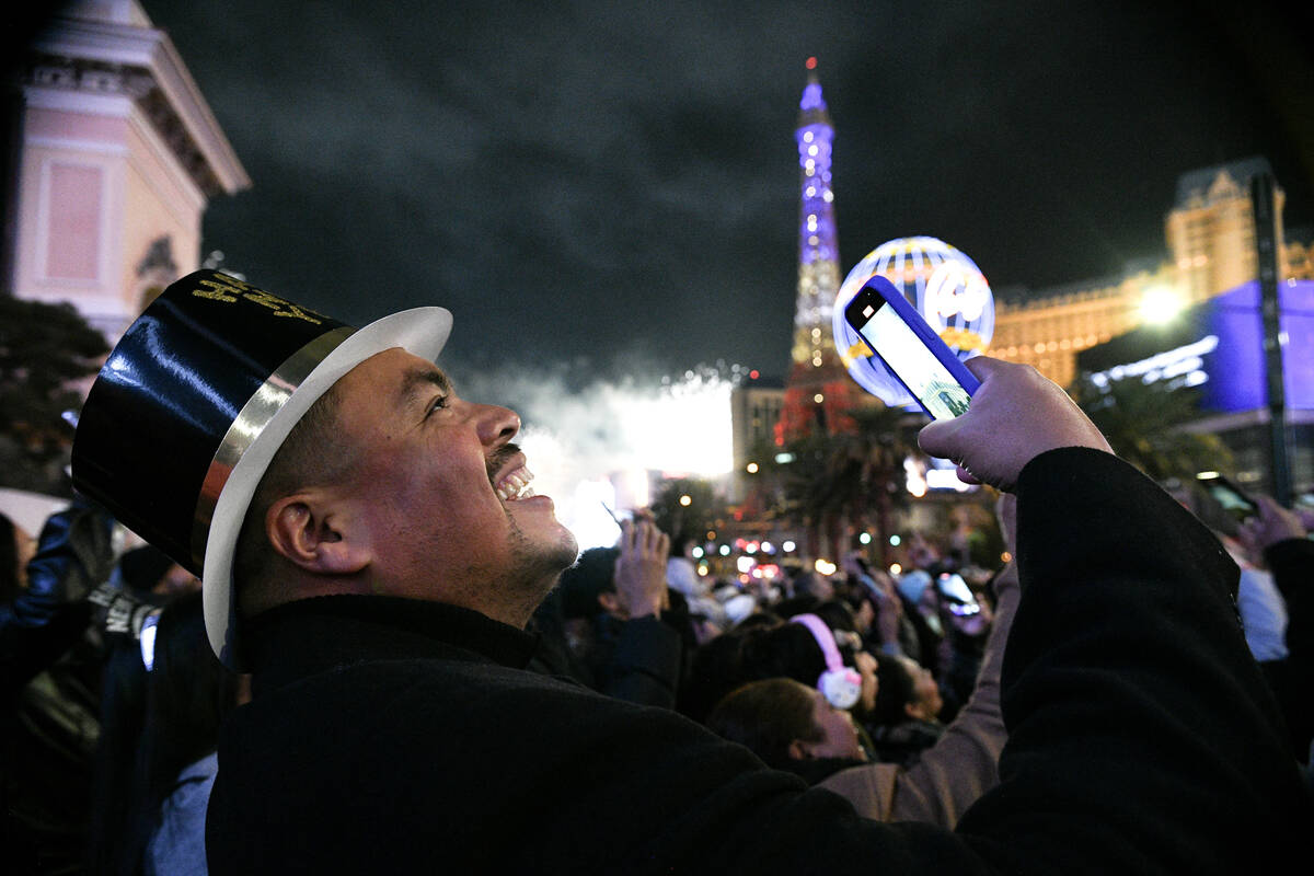 Carlos Valdez from Los Angeles smiles while watching New Year’s Eve fireworks on the Str ...