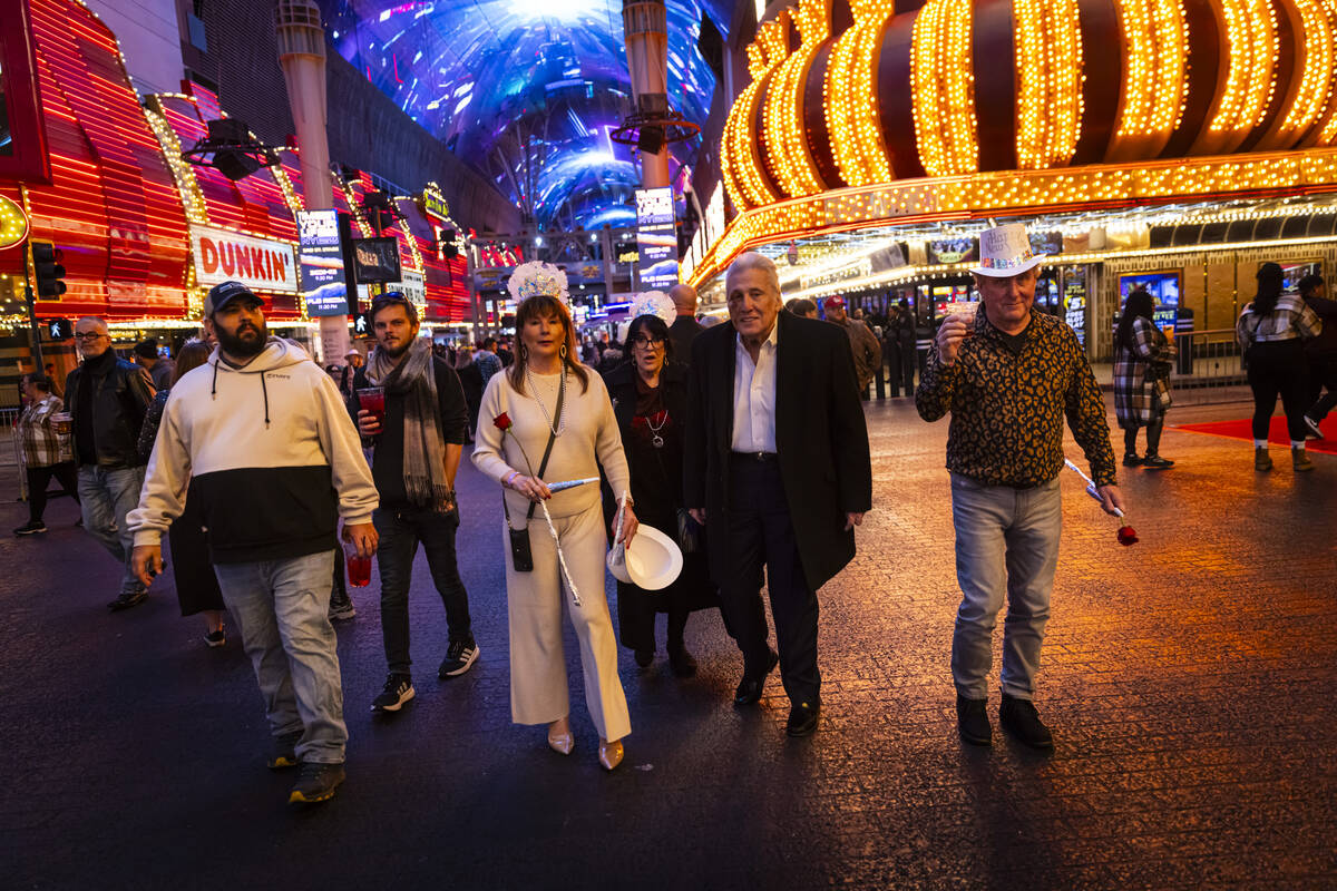 New Year's Eve revelers wander along the Fremont Street Experience Tuesday, Dec. 31, 2024, in d ...