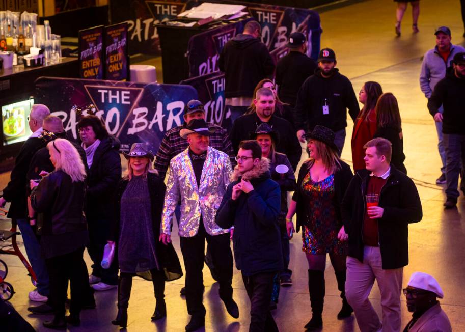 New Year's Eve revelers walk around the Fremont Street Experience Tuesday, Dec. 31, 2024, in do ...