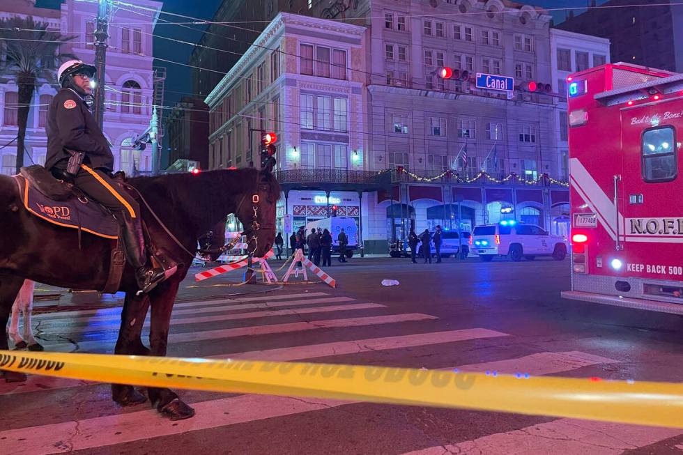 A mounted police officer arrives on Canal Street after a vehicle drove into a crowd earlier in ...