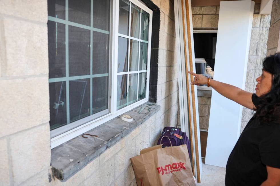 Evelyn Paguirigan points to broken windows at her home across the street from where a New Year' ...