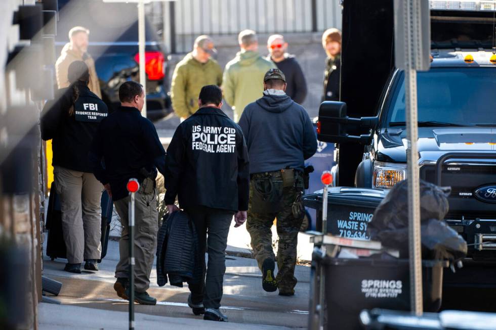 Investigators search a townhouse in northeastern Colorado Springs, Colo., Thursday, Jan. 2, 202 ...