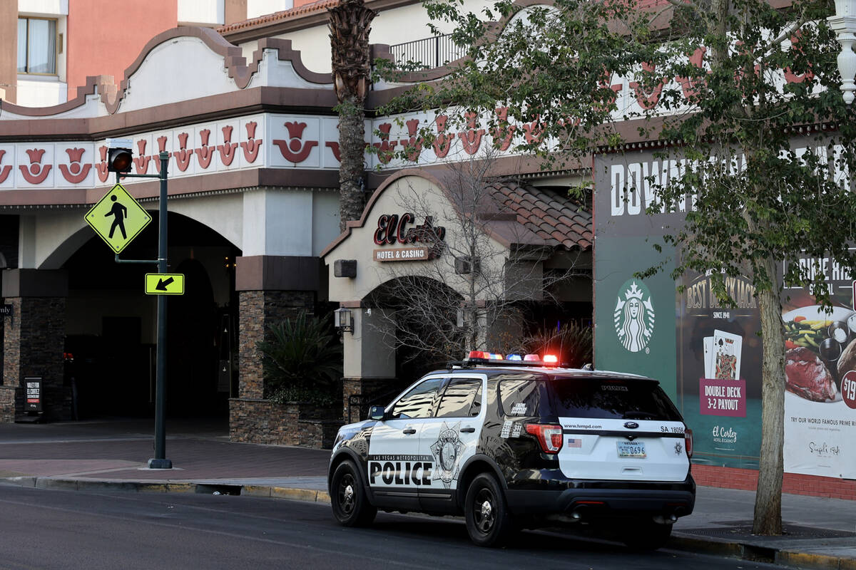 A Las Vegas police vehicle is seen with flashing lights at 6th Street near Ogden Avenue in down ...