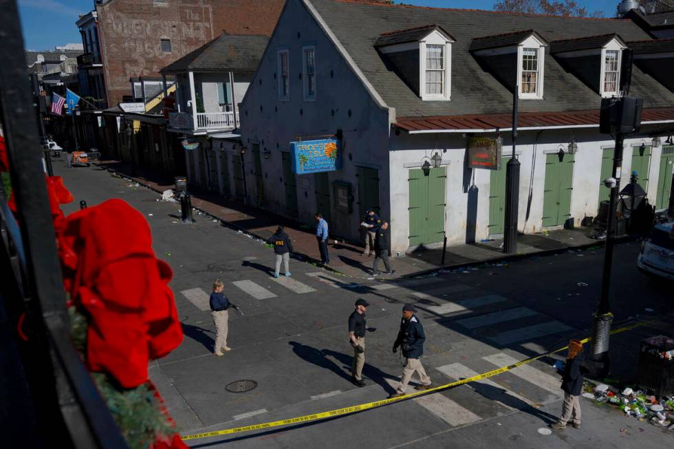 Members of the FBI walk around Bourbon Street during the investigation of a truck fatally crash ...