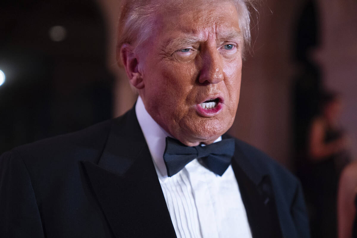 President-elect Donald Trump speaks to reporters before a New Year's Eve party at Mar-a-Lago, T ...