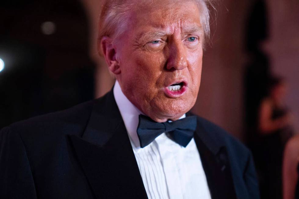 President-elect Donald Trump speaks to reporters before a New Year's Eve party at Mar-a-Lago, T ...