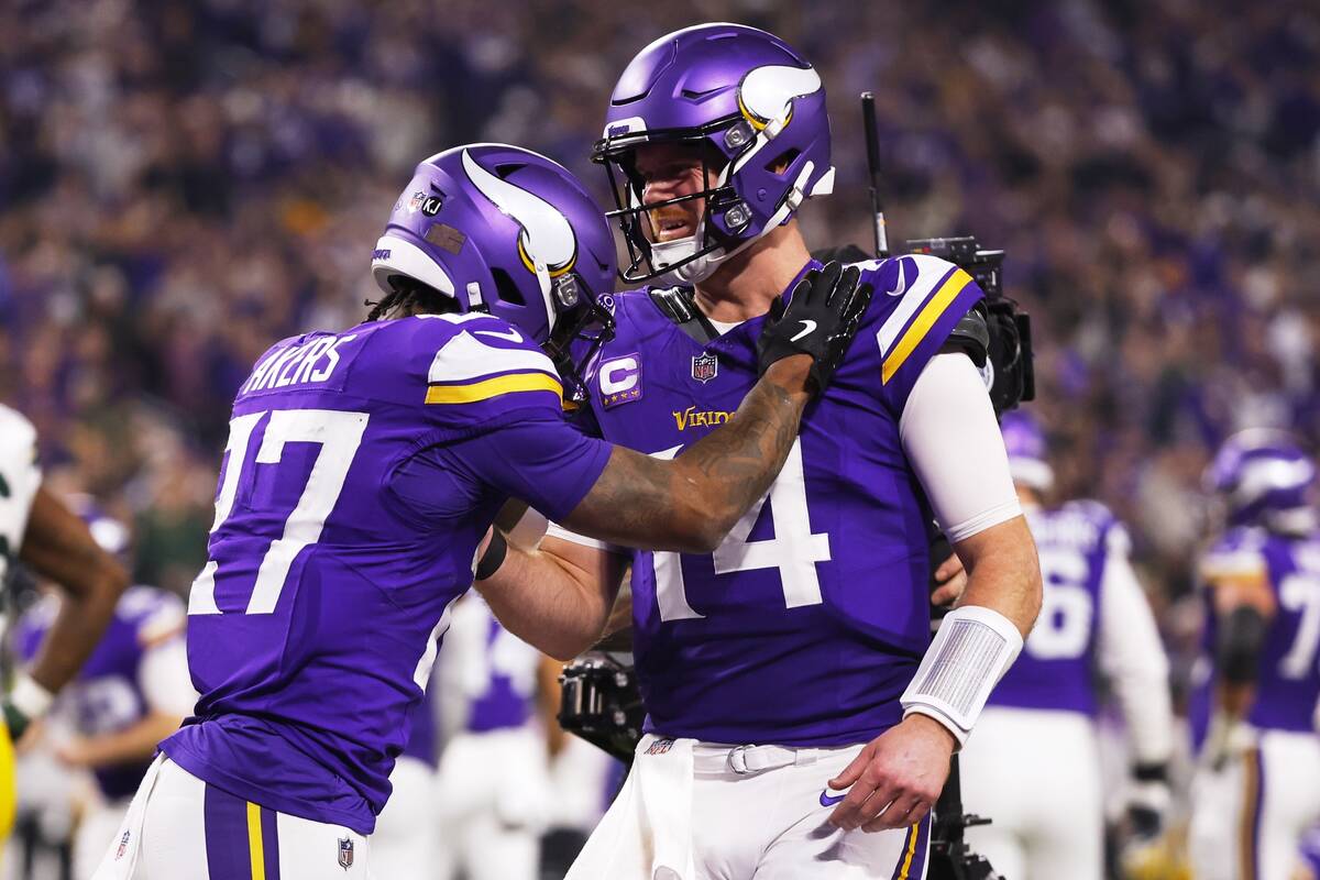 Minnesota Vikings' Sam Darnold congratulates Cam Akers on a touchdown catch during the second h ...