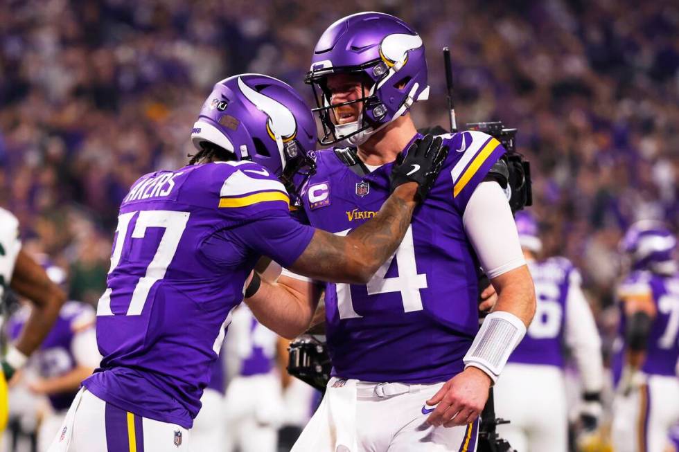 Minnesota Vikings' Sam Darnold congratulates Cam Akers on a touchdown catch during the second h ...