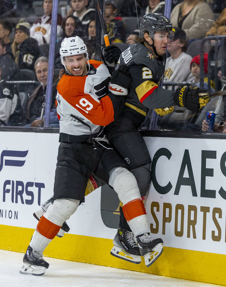 Philadelphia Flyers right wing Garnet Hathaway (19) checks Golden Knights defenseman Zach White ...