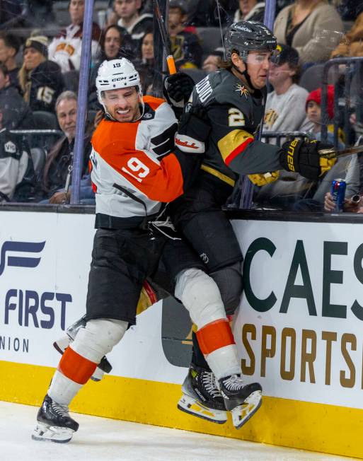 Philadelphia Flyers right wing Garnet Hathaway (19) checks Golden Knights defenseman Zach White ...