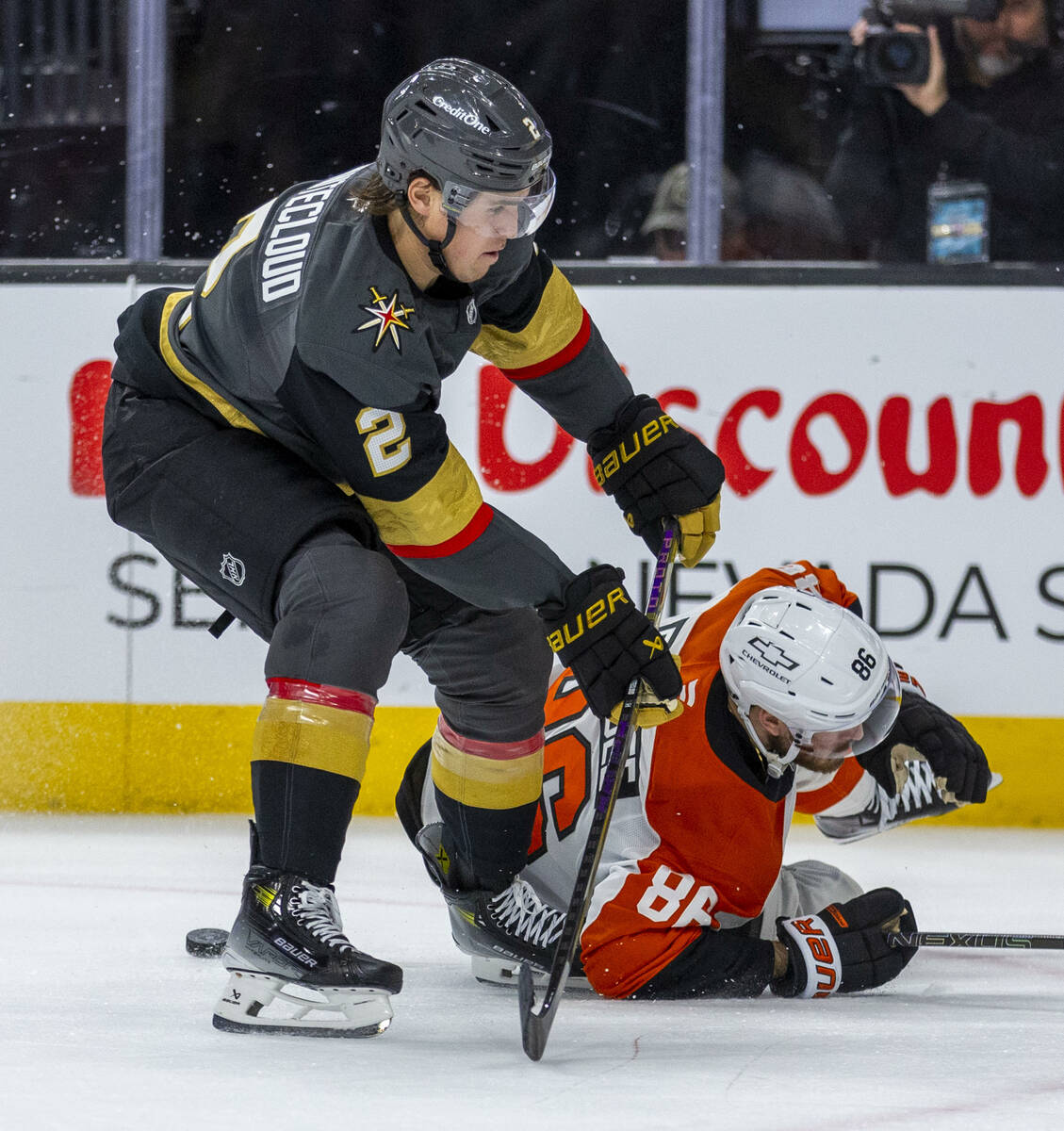 Golden Knights defenseman Zach Whitecloud (2) takes the puck away from Philadelphia Flyers left ...