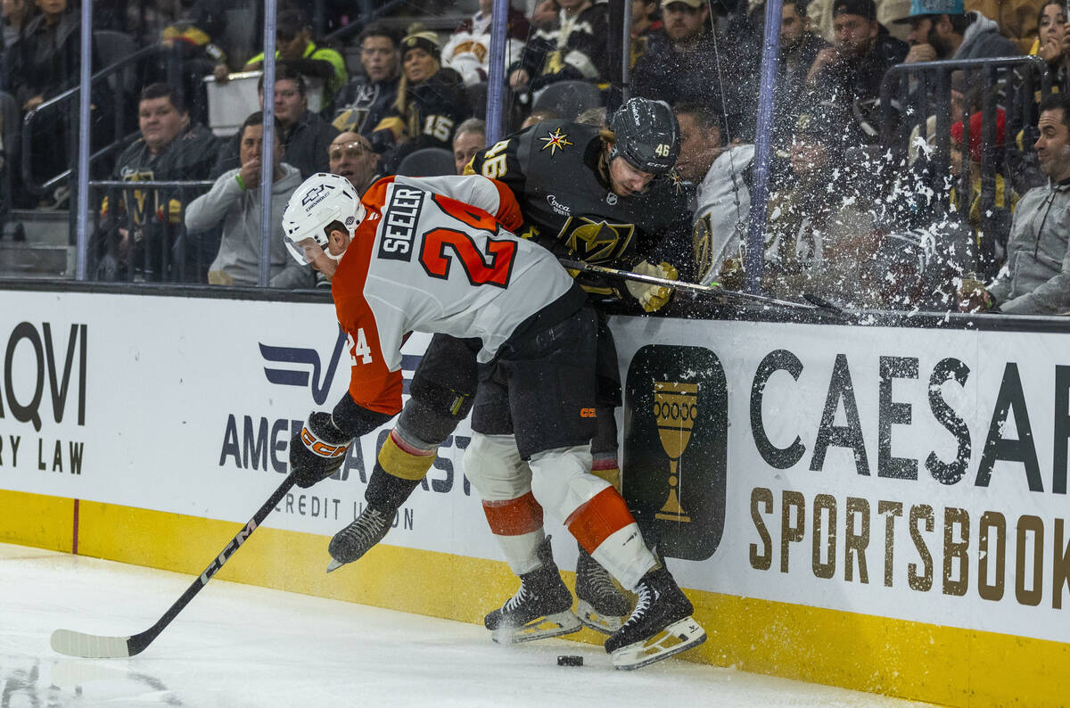 Golden Knights Wing Jonas Rondbjerg (46) battles for the puck on the boards with Philadelphia F ...