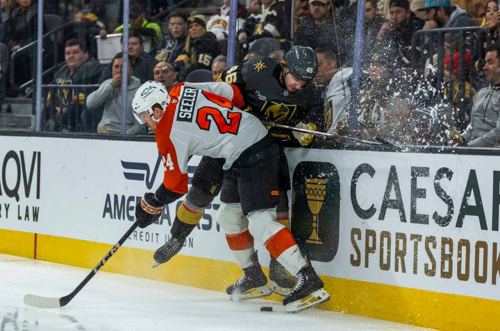 Golden Knights Wing Jonas Rondbjerg (46) battles for the puck on the boards with Philadelphia F ...