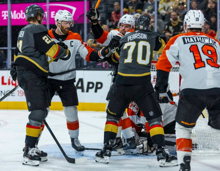 Golden Knights left wing Tanner Pearson (70) fights near the net with Philadelphia Flyers defen ...