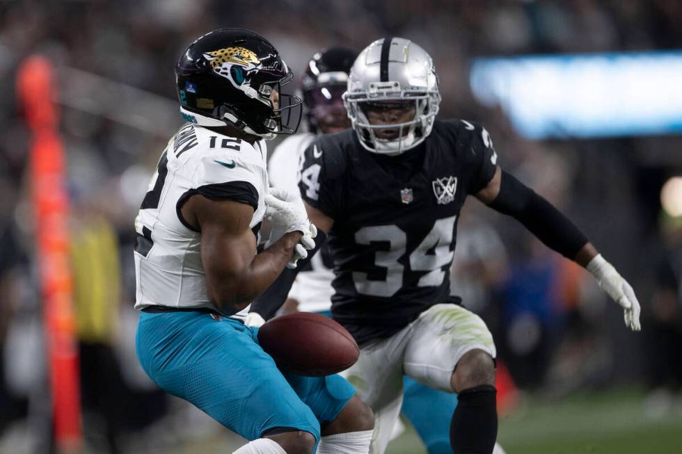 Jacksonville Jaguars wide receiver Devin Duvernay (12) fumbles the football as Raiders safety T ...