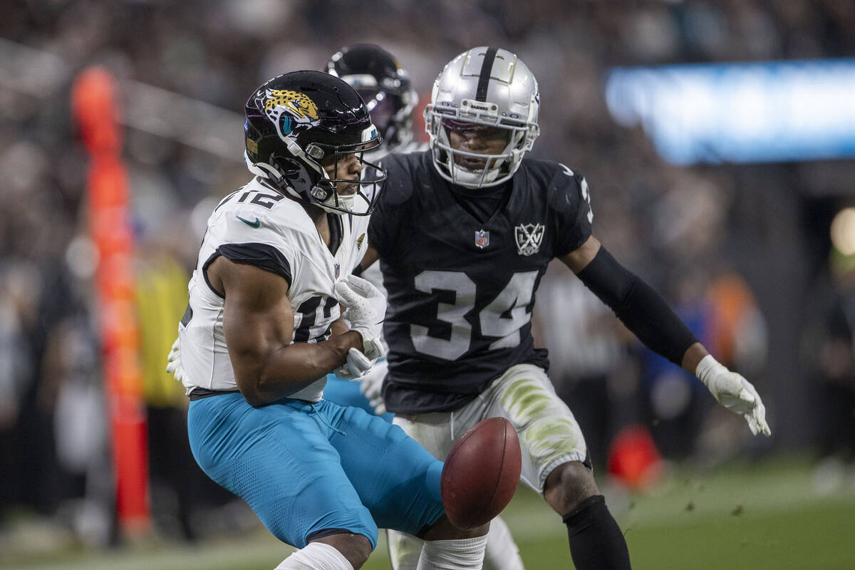 Jacksonville Jaguars wide receiver Devin Duvernay (12) fumbles the football as Raiders safety T ...