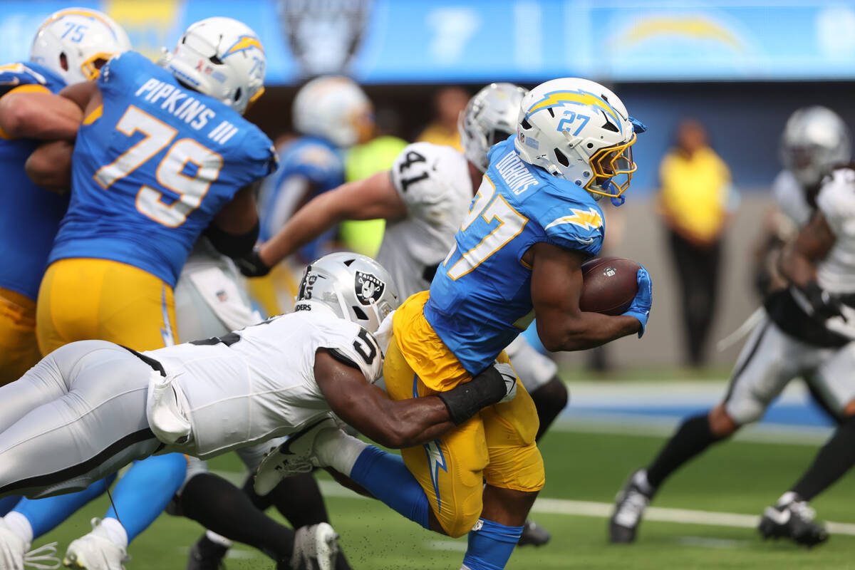 Raiders linebacker Divine Deablo (5) can’t tackle Los Angeles Chargers running back J.K. ...