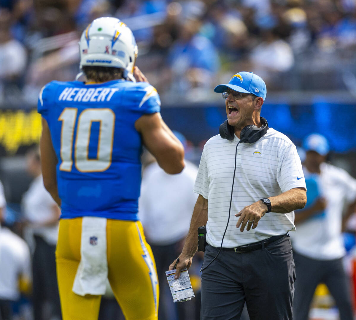 Los Angeles Chargers head coach Jim Harbaugh yells on the field against the Raiders during the ...