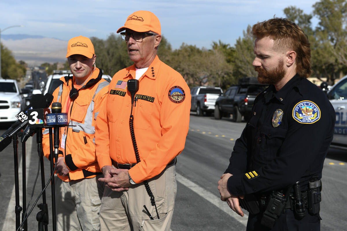 Ian Billings, left, and Mark Speer from Red Rock Search & Rescue are joined by Henderson police ...