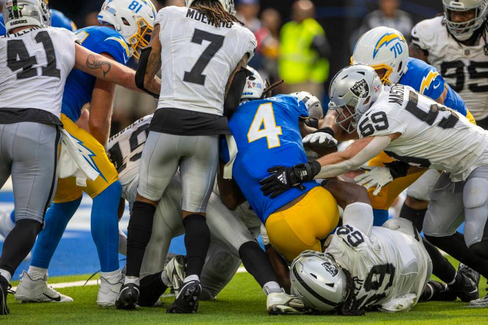 Raiders wide receiver Jalen Guyton (4) is tackled on a two-point attempt leading to a fight bet ...