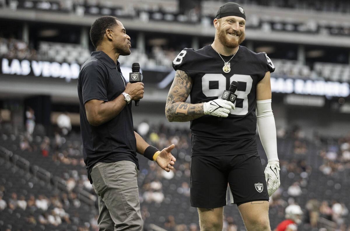 Former Raider player Eric Allen, left, interviews Raiders defensive end Maxx Crosby (98) during ...