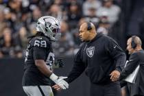 Raiders head coach Antonio Pierce congratulates Raiders defensive tackle Adam Butler (69) on hi ...