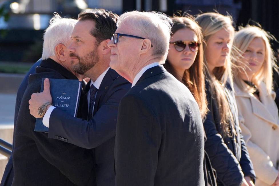 Jack Cater, front center, and grandson Jason Carter, greet dignitaries as the hearse carrying t ...