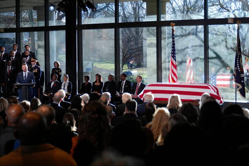 Jason Carter, grandson of former President Jimmy Carter, speaks as the flag-draped casket of fo ...