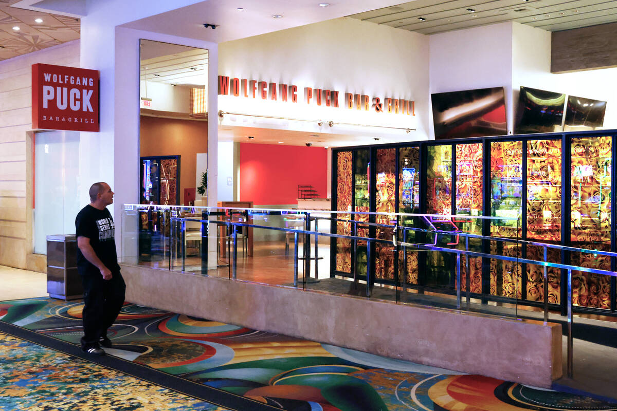 A guest walks past Wolfgang Puck restaurant at MGM Grand, on Monday, Jan. 6, 2025, in Las Vegas ...