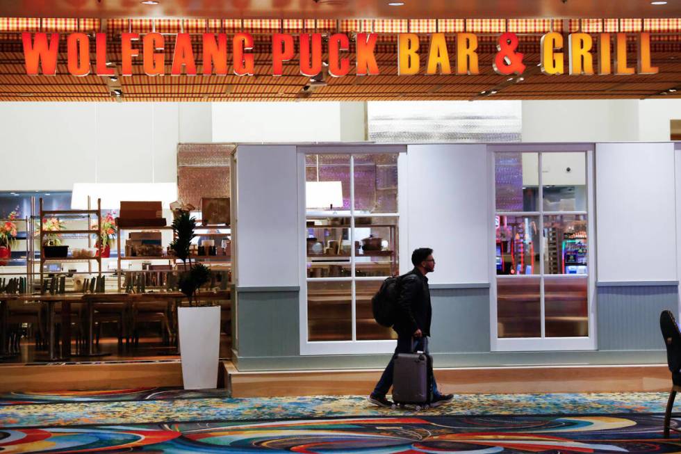 A guest walks past Wolfgang Puck restaurant at MGM Grand, on Monday, Jan. 6, 2025, in Las Vegas ...