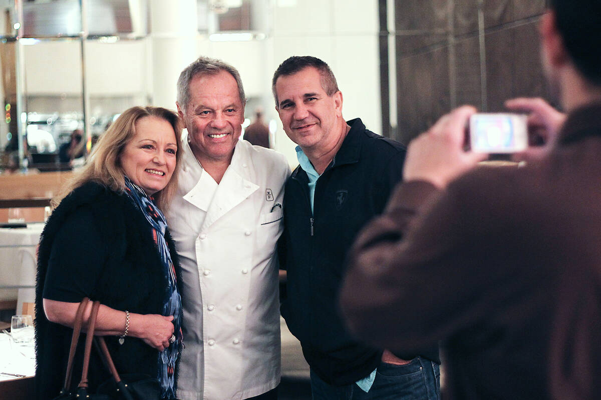 Celebrity Chef Wolfgang Puck poses for a photo with patrons Robyn Wood, left, and Brett Maxwell ...