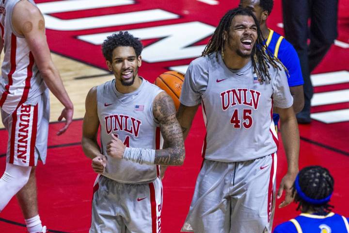 UNLV guard Jailen Bedford (14) and forward Jeremiah "Bear" Cherry (45) are pumped after a run a ...