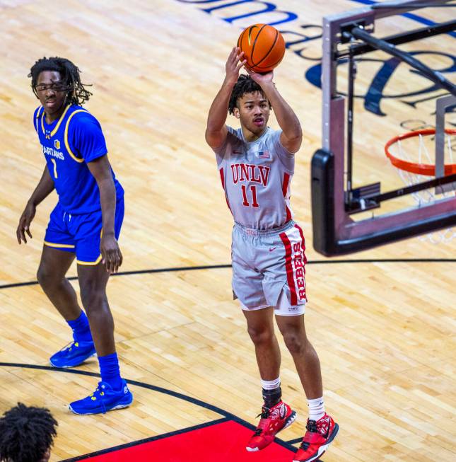 UNLV guard Dedan Thomas Jr. (11) gets off a jump shot past San Jose State Spartans guard Will M ...