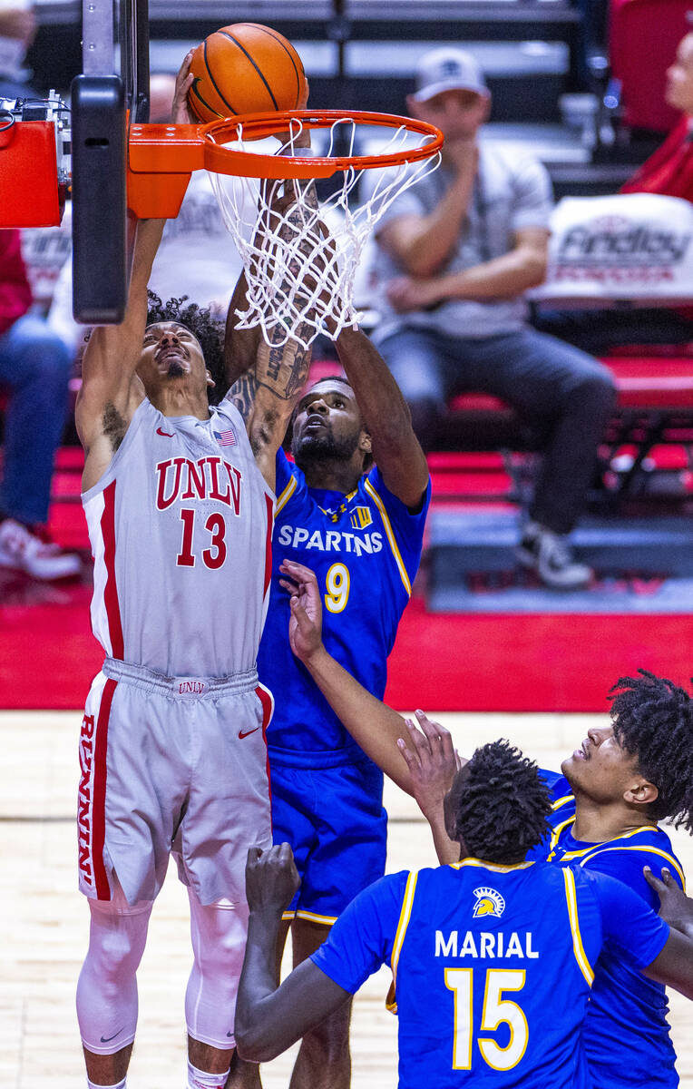 UNLV guard Brooklyn Hicks (13) sets up to score a rebound over San Jose State Spartans guard Jo ...