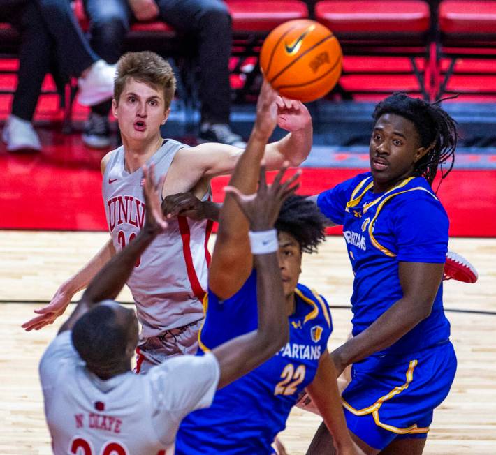 UNLV guard Julian Rishwain (20) looks after his pass over San Jose State Spartans guard Will Mc ...