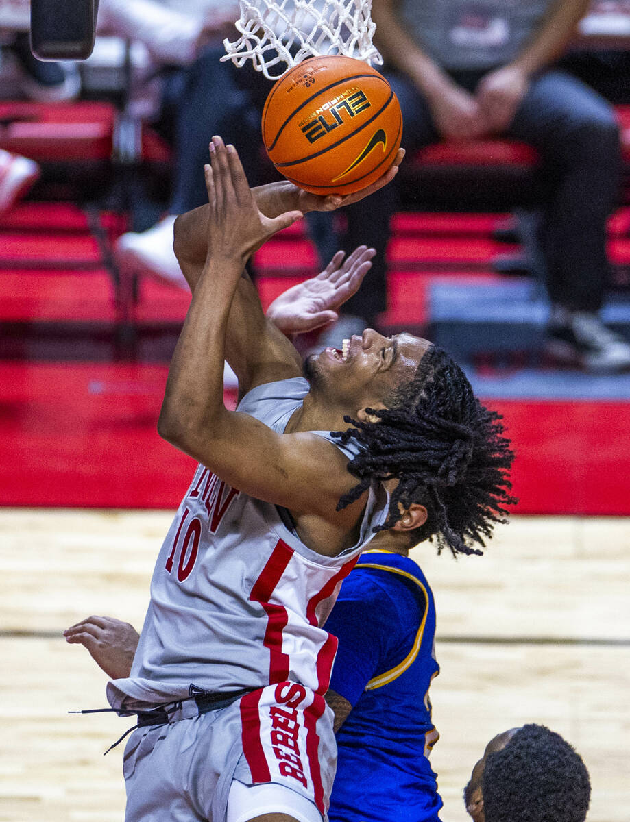 UNLV guard Jaden Henley (10) looks to shoot over San Jose State Spartans guard Josh Uduje (9) d ...