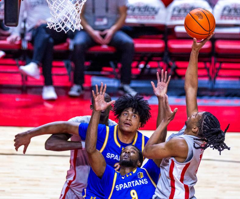 UNLV guard Jaden Henley (10) looks to shoot over San Jose State Spartans guard Josh Uduje (9) d ...