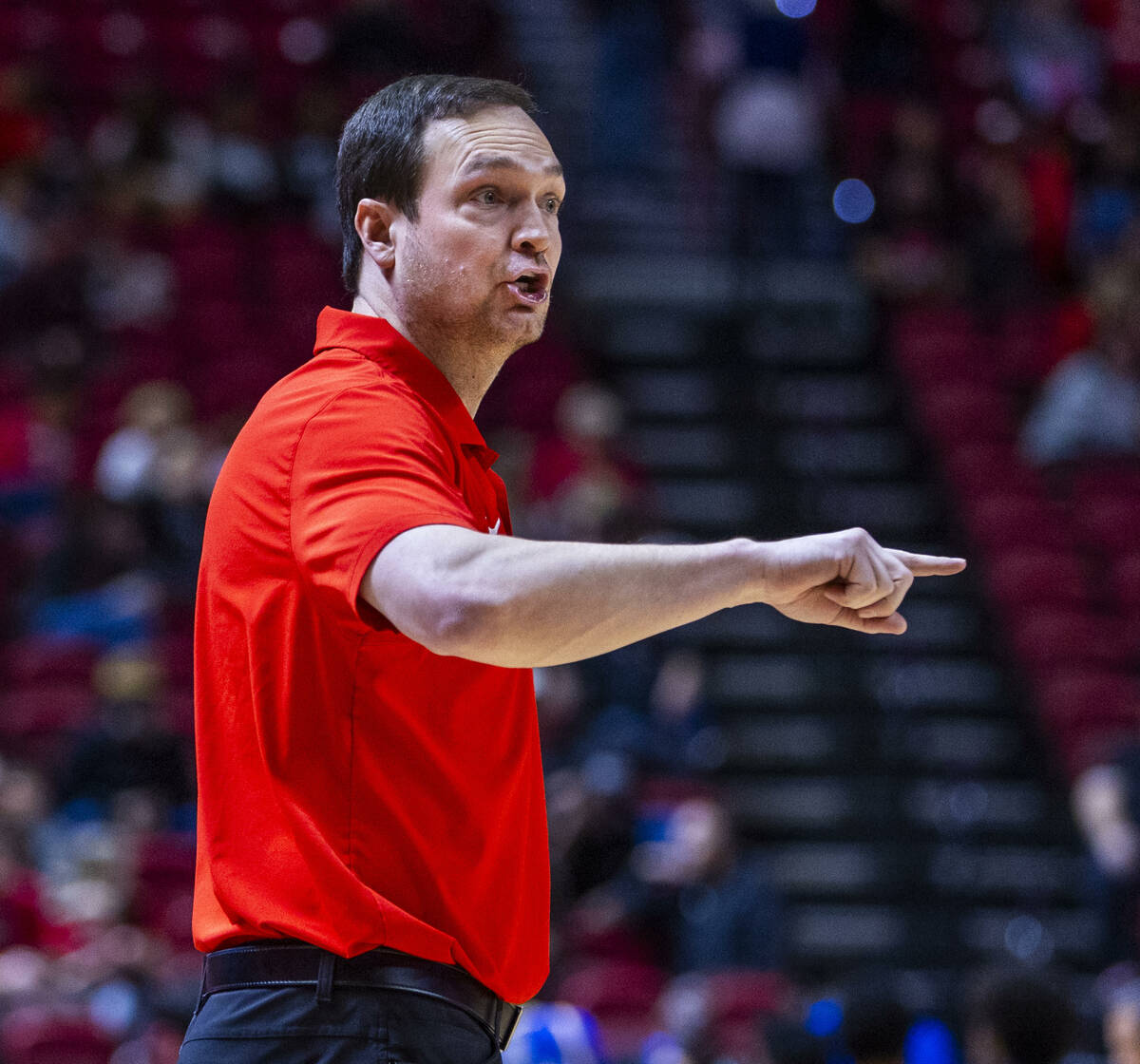 UNLV head coach Kevin Kruger counsels his players against the San Jose State Spartans during th ...