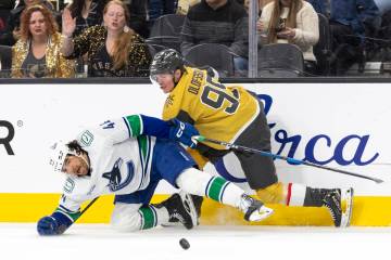 Golden Knights right wing Victor Olofsson (95) and Vancouver Canucks left wing Kiefer Sherwood ...