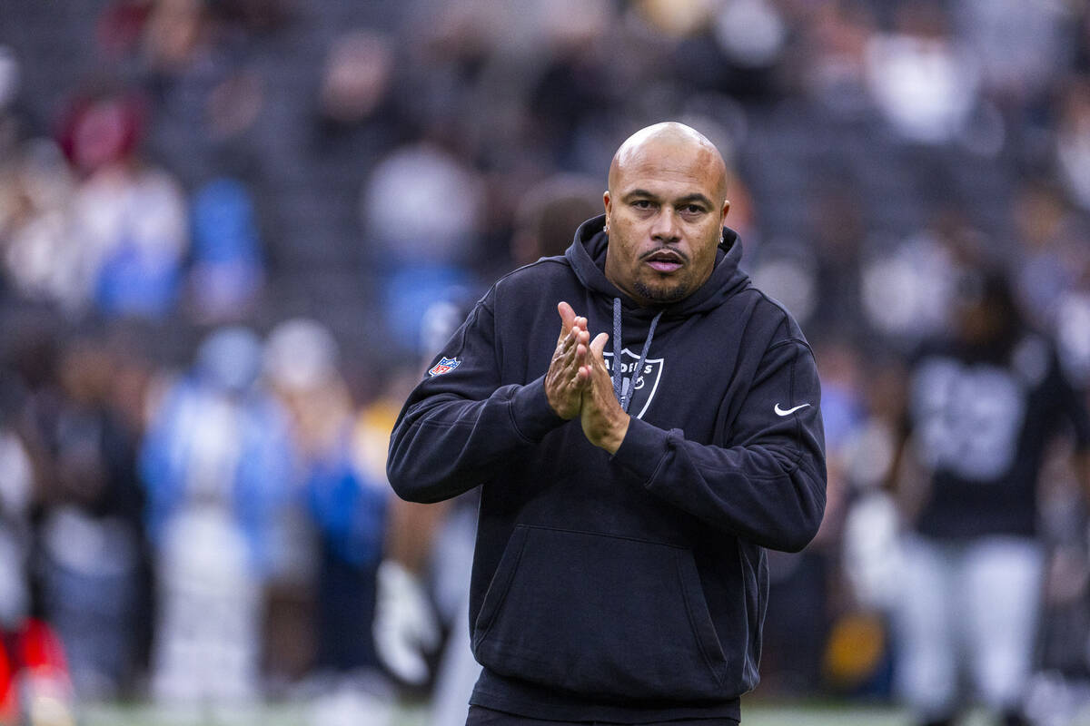 Raiders head coach Antonio Pierce looks to his players during warm ups before facing the Los An ...