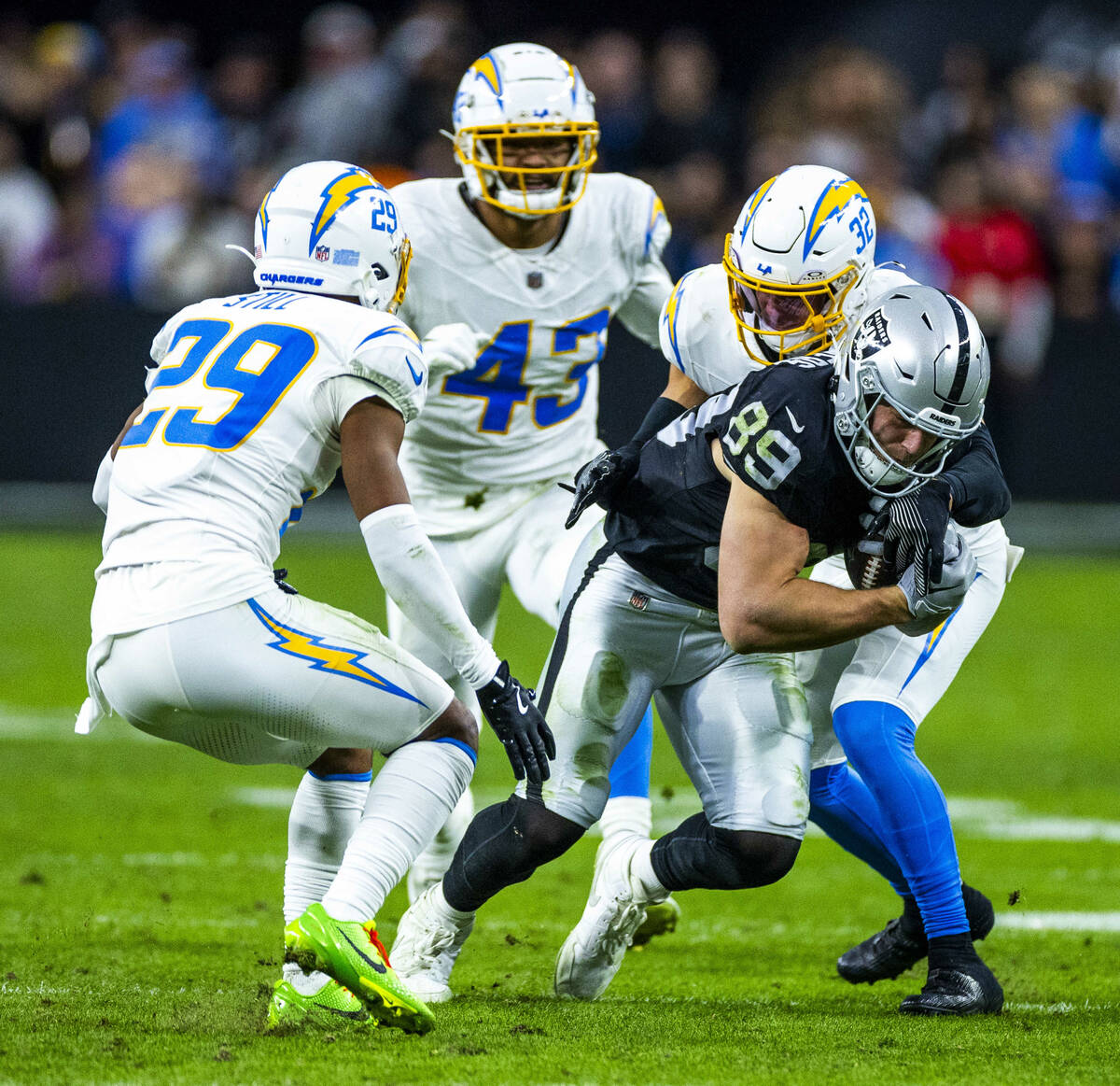 Raiders tight end Brock Bowers (89) runs after a catch past as he runs away from Los Angeles Ch ...