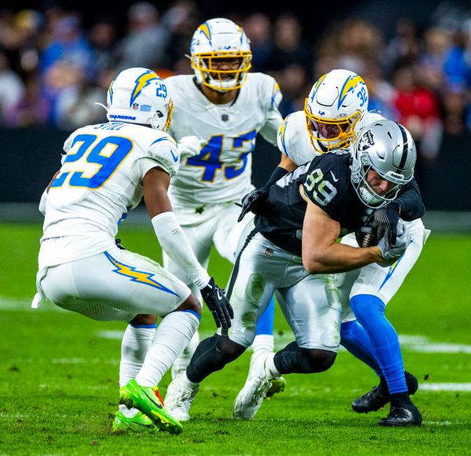 Raiders tight end Brock Bowers (89) runs after a catch past as he runs away from Los Angeles Ch ...