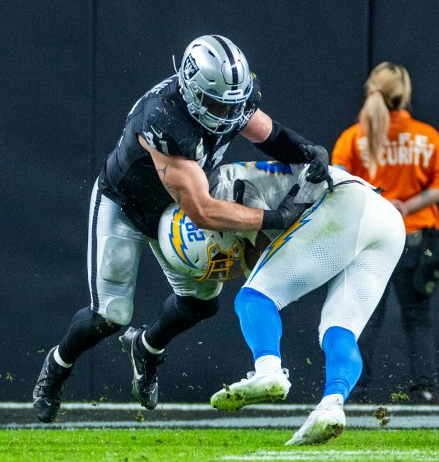 Raiders linebacker Robert Spillane (41) stops Los Angeles Chargers running back Hassan Haskins ...